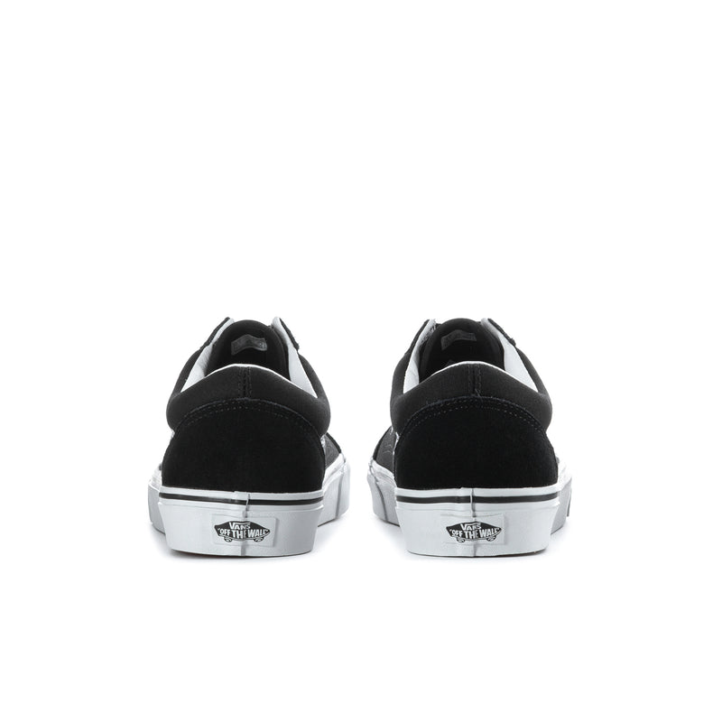 Men's black low-top sneakers, heel view with white branding patch and white rubber sole