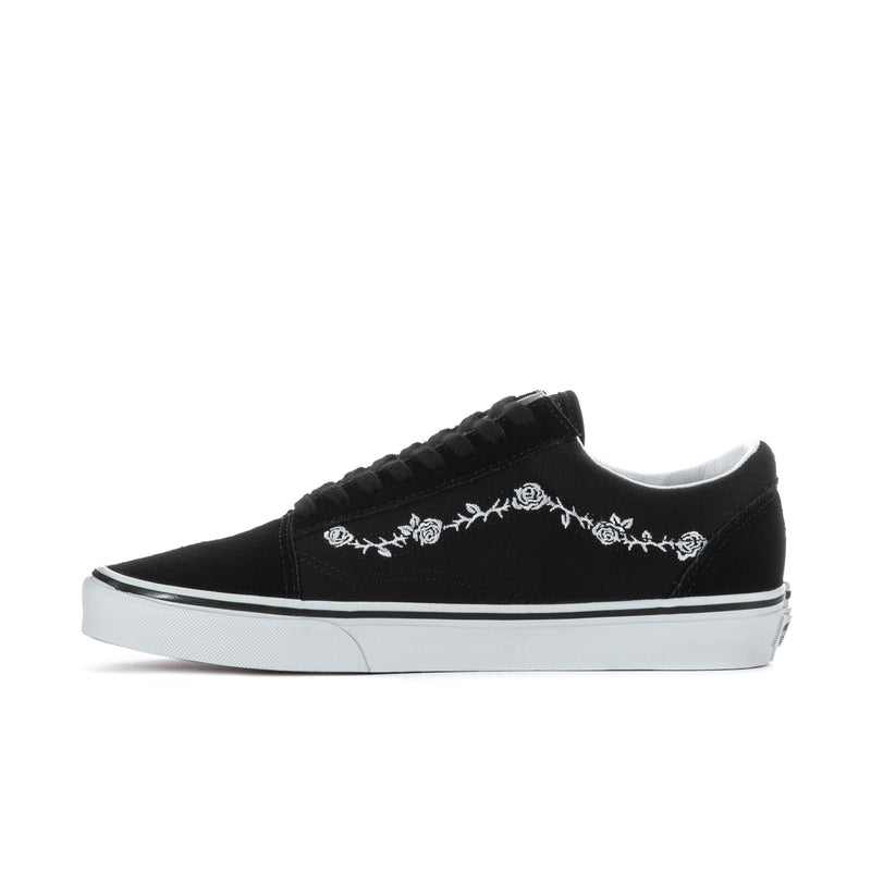 Men's black low-top sneakers with white floral embroidery on side and white rubber sole