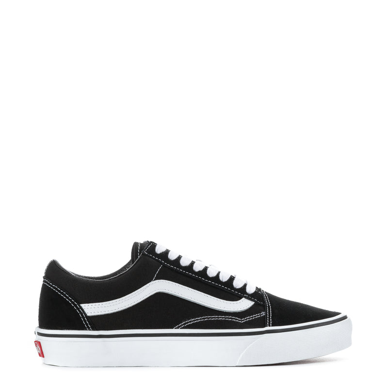 Black low-top sneakers with white side stripe and white lace-up closure