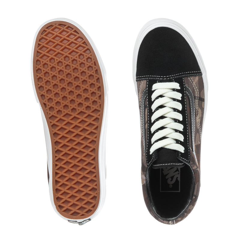 Youth low-top sneaker outsole and side view, black camo upper, white laces
