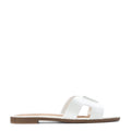 White women's slide sandal with H-band strap and flat brown outsole
