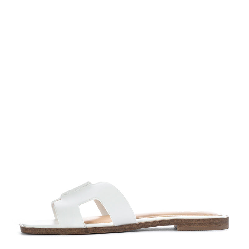 White women's H-band slide sandal, side view with open toe and flat sole