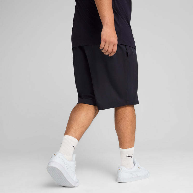 Navy mens woven shorts showing hem and elastic waist; Puma cat logo visible.