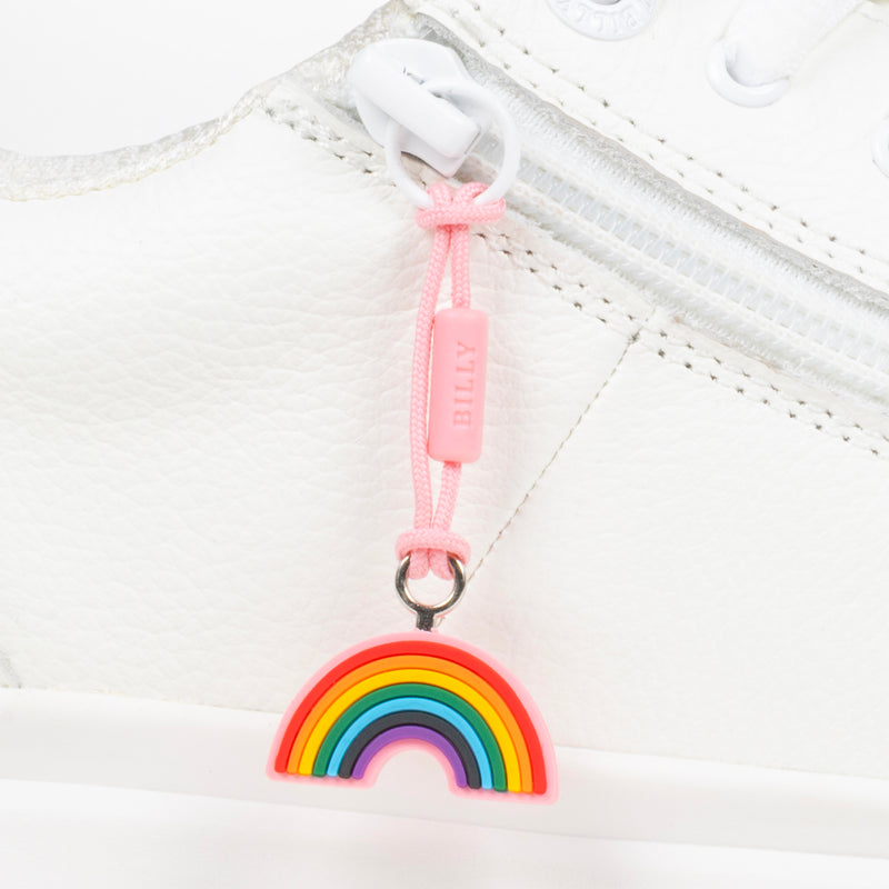 Rainbow charm on a white sneaker with a pink pull tab.