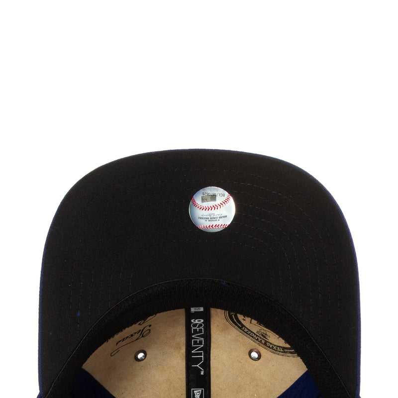 Black baseball cap top view with logo button and inner strap