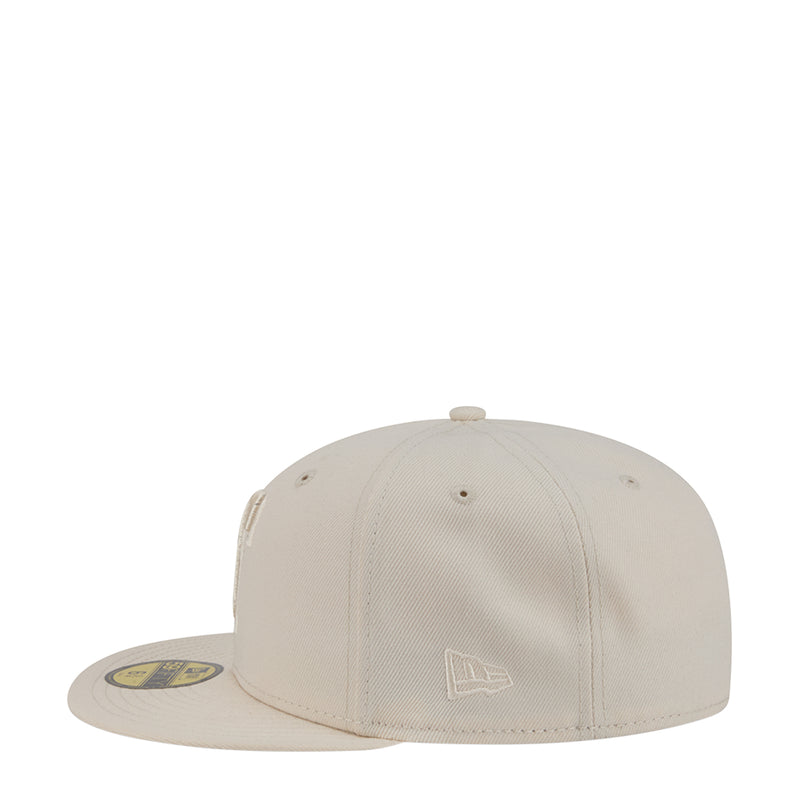 Light cream baseball cap with tonal side emblem and curved brim.