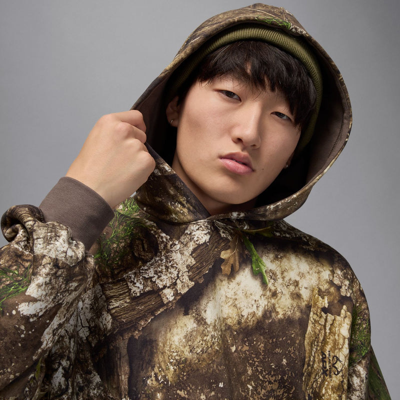 Men's camouflage hoodie with dark hood lining and textured fabric pattern
