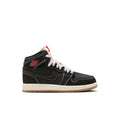 Kids black high-top sneakers with white laces, red accents, and a gum-toned sole