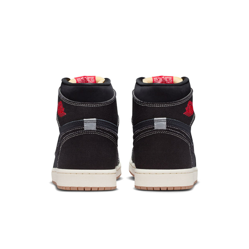 Black high-top sneakers showing rear view, red tongue accents, and gum outsole