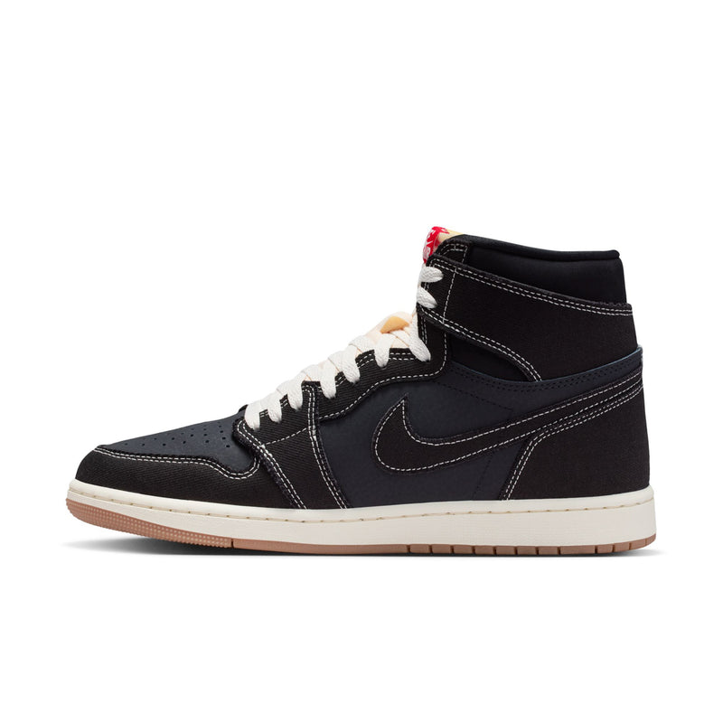 Black high-top sneakers with white laces, Nike Swoosh, and tan outsole strip