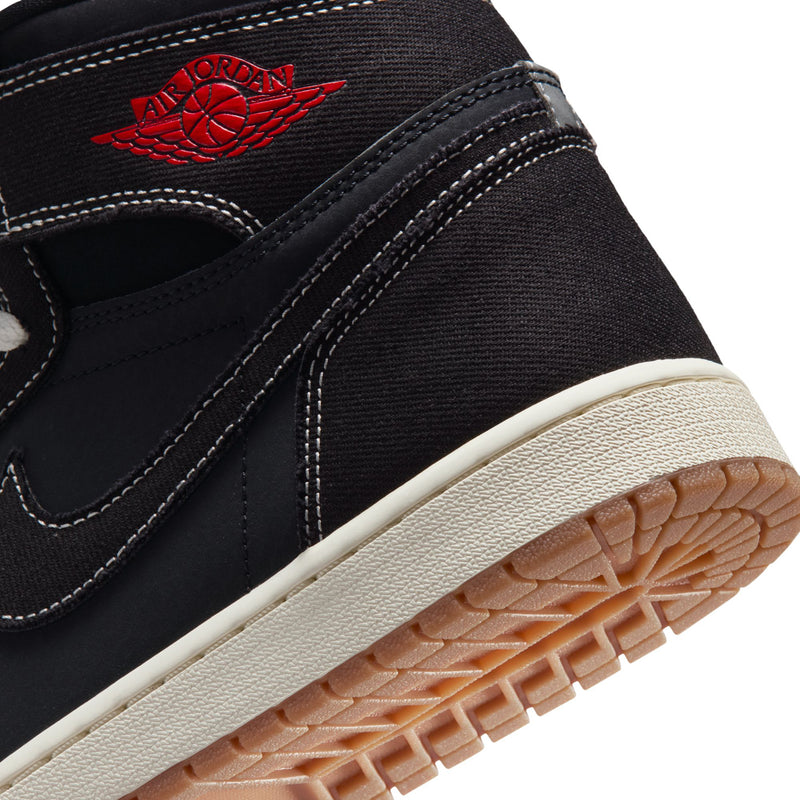 Black high-top sneakers close-up with red Jordan logo and textured gum outsole edge