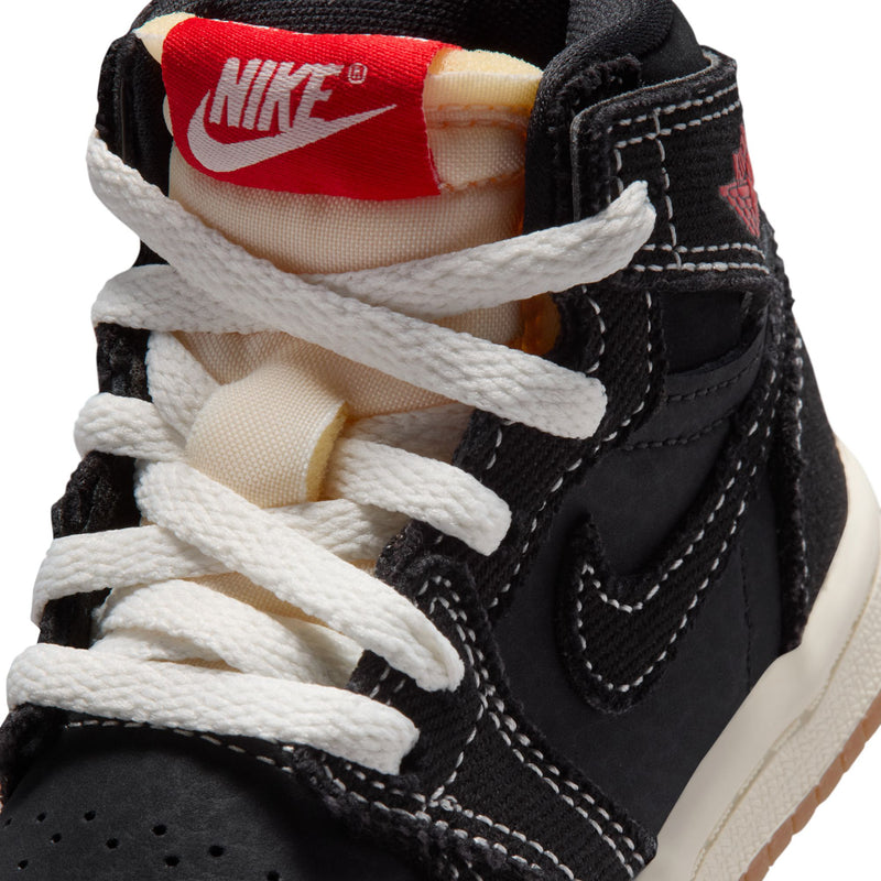 Toddler black high-top sneakers close-up of white laces and red Nike heel label