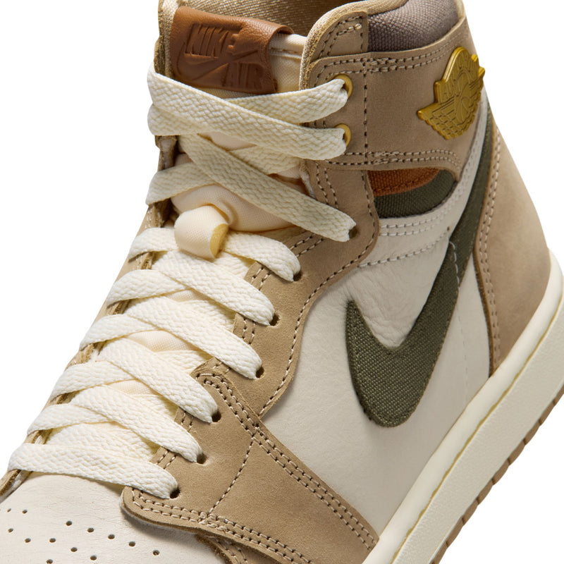 Close-up of high-top sneakers with sail laces, tan suede, and olive swoosh