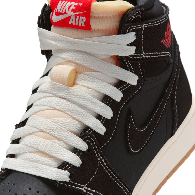Black youth high-top sneaker close-up with white laces and Nike Air heel label.