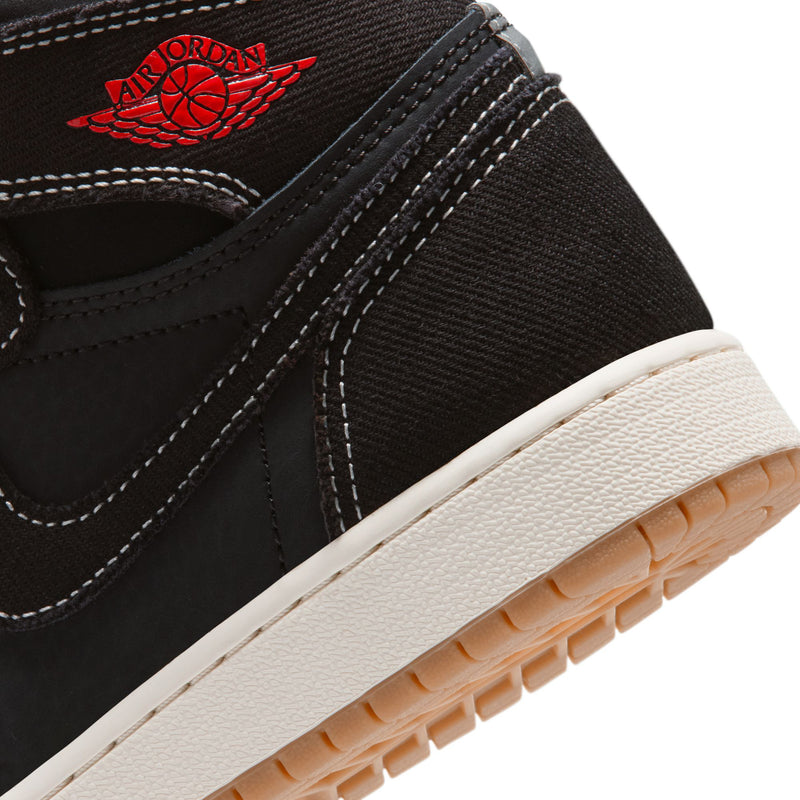 Black youth high-top sneaker close-up with Air Jordan wing logo and white midsole edge.