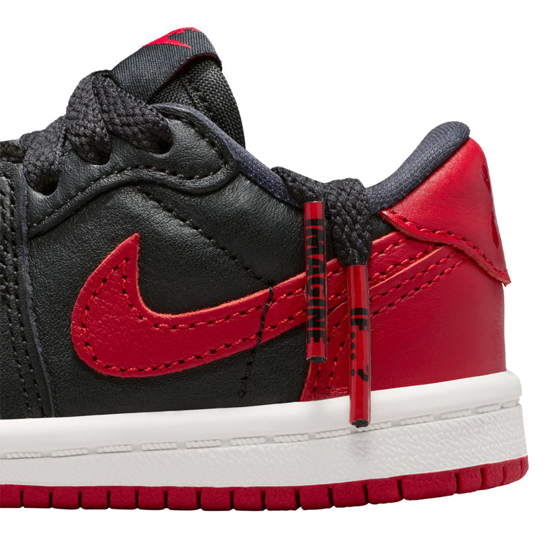 Toddler sneaker close-up, black and red panels with stitched Nike swoosh