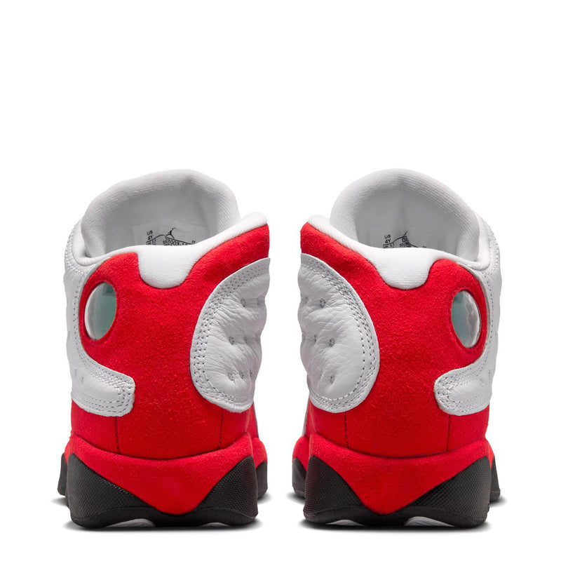 Youth sneaker back view with white leather heel and red midsole, black rubber outsole