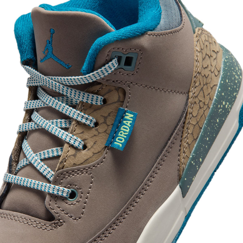 Kids retro basketball sneakers close-up of lace area, taupe suede with blue laces and 'JORDAN' tab