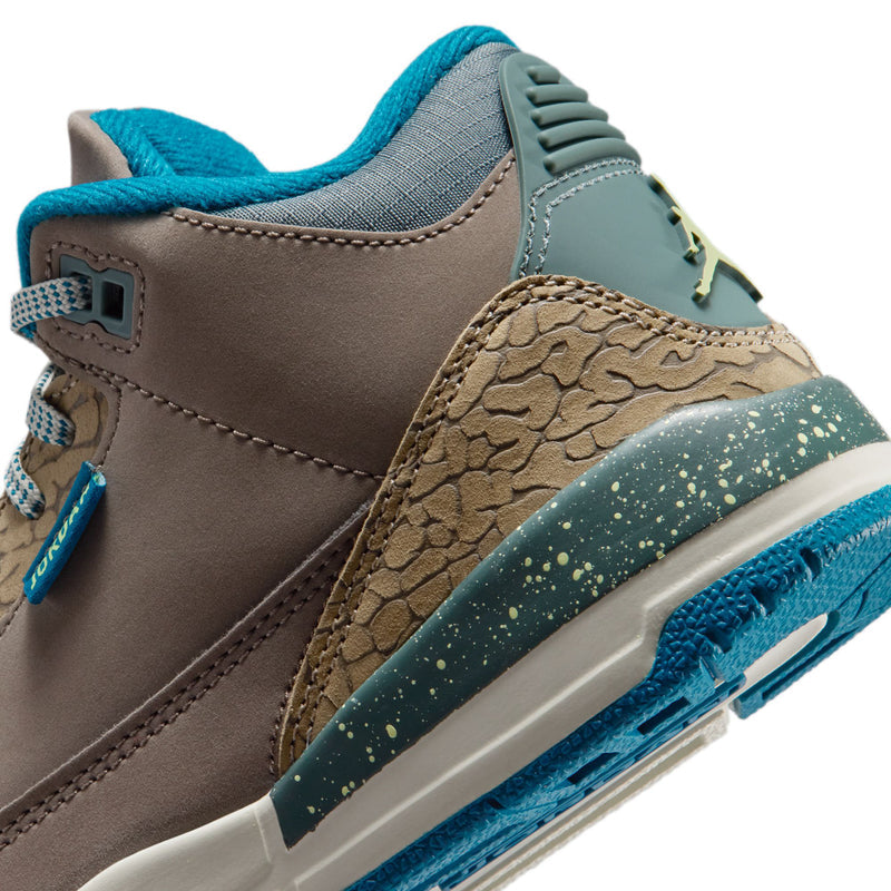 Kids retro basketball sneakers close-up, side panel with elephant print and speckled teal midsole