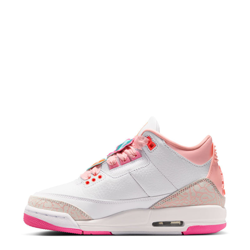 Youth sneaker side view: white leather, pink trim, multicolor laces, Air unit