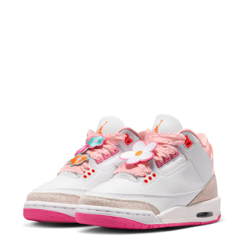 Youth sneaker front view with white upper, pink floral laces, flower appliques, Air sole