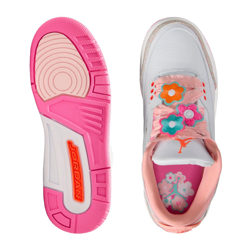 Sneaker outsole and interior: pink tread with Jumpman emblem, floral insole print
