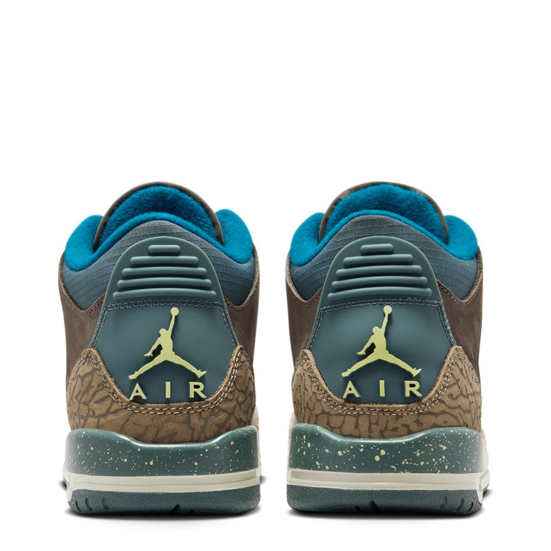 Back view of youth Jordan sneakers, AIR heel text with teal lining and speckled sole