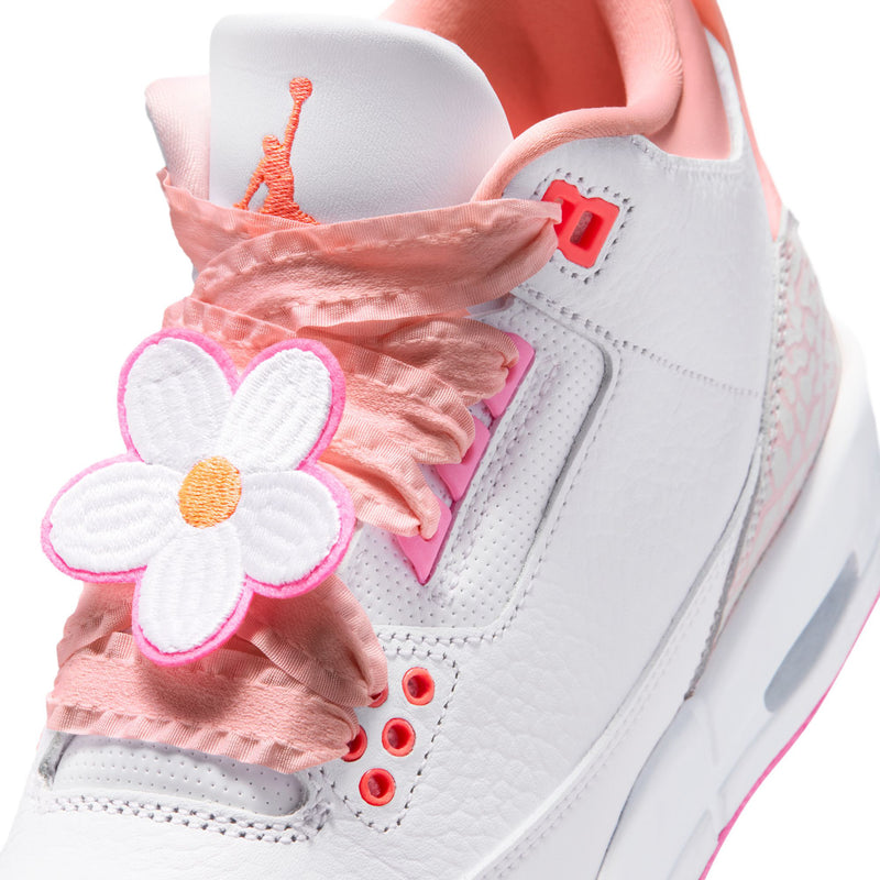 Sneaker tongue and lace detail with pink ruffle and white flower appliques