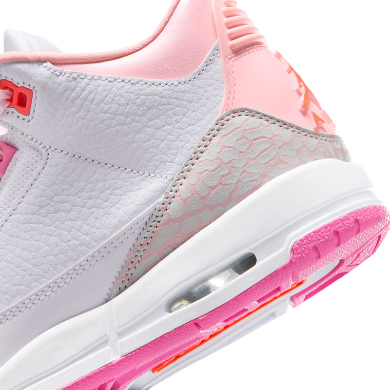 Sneaker side close-up: white leather, textured pink panel, visible Air window