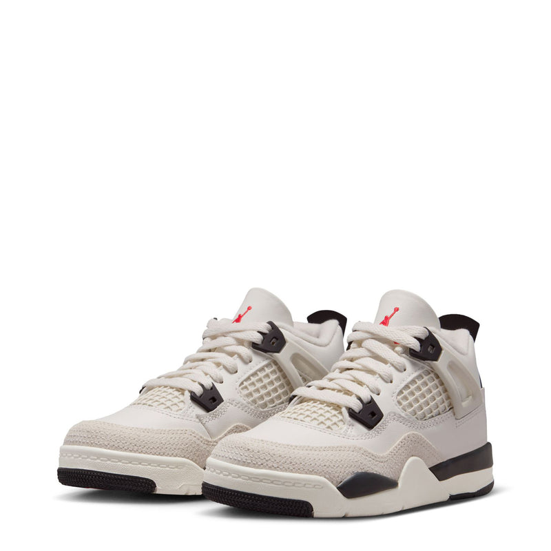 Pair of kids white low-top sneakers with black midsoles and red Jumpman accents