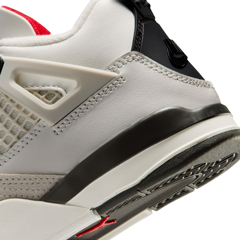 Kids white sneaker side close-up with black strap and translucent side window