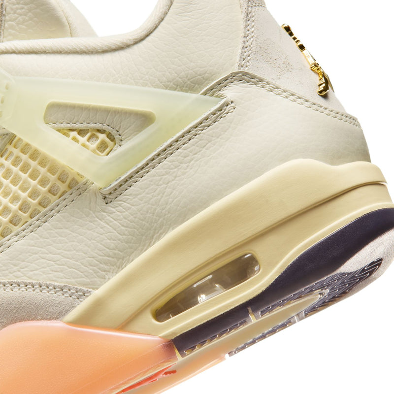 Women’s Retro 4 midsole close-up with air window, orange accent, and cream outsole