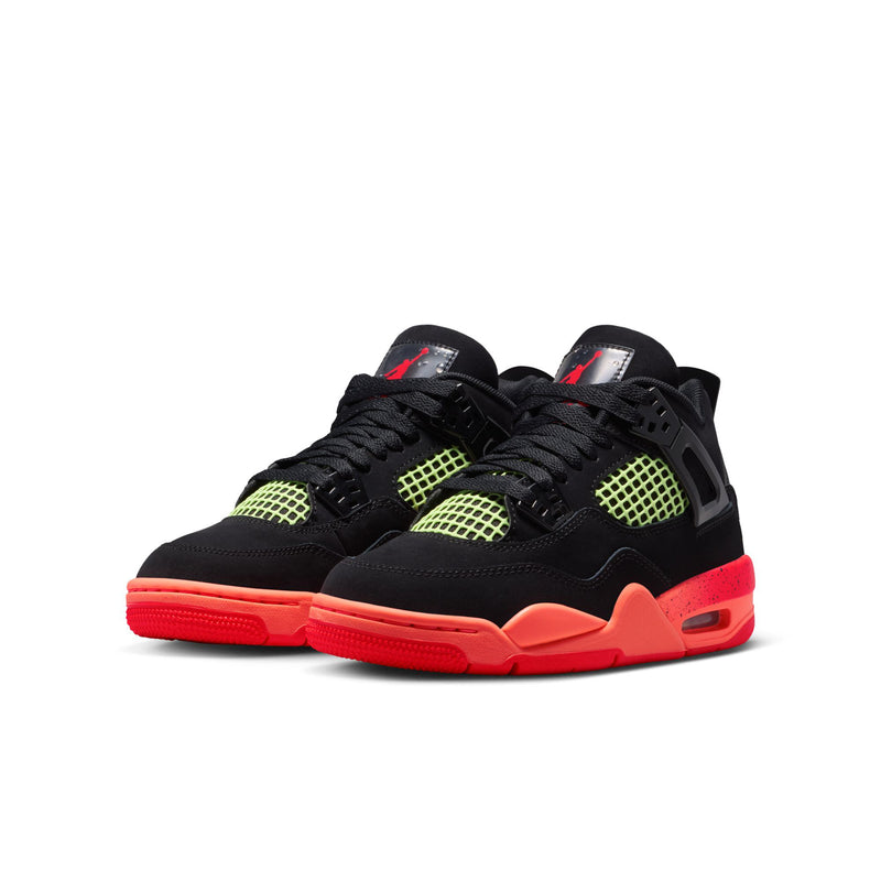 Youth black basketball shoes with neon green grid panels and red-orange outsole