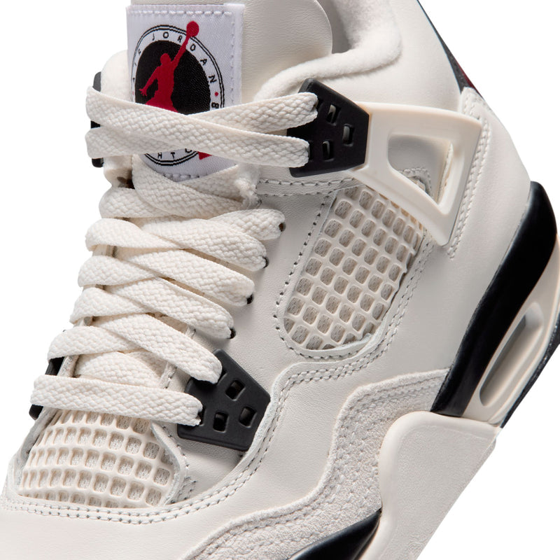 Close-up youth sneaker upper with textured mesh, white laces, black strap details