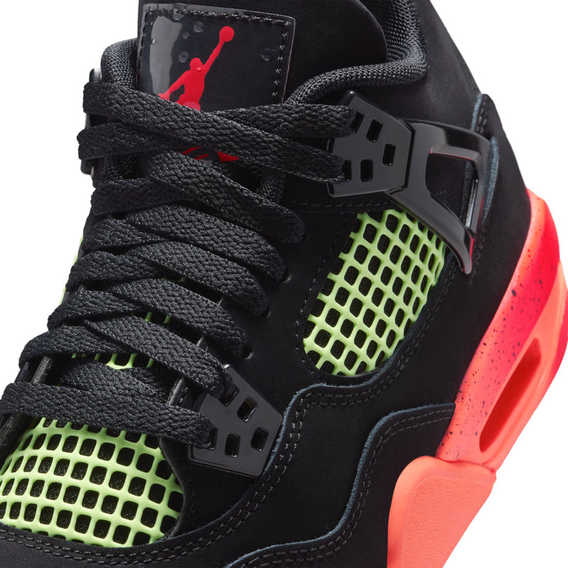 Youth black sneaker close-up: black laces, neon green grid, red Air Jordan detail