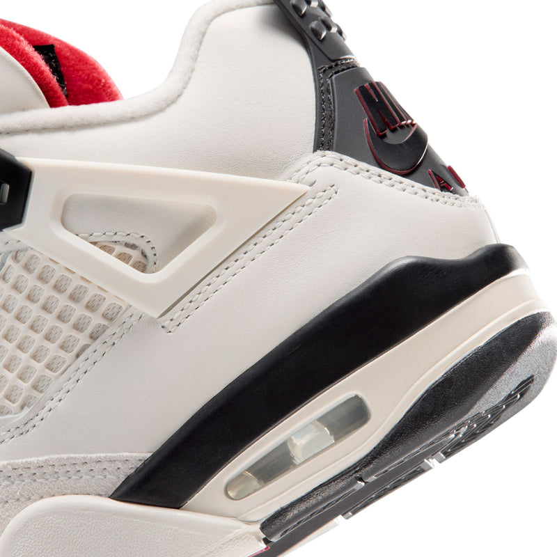 Youth sneaker close-up showing black air unit midsole and sail upper panels
