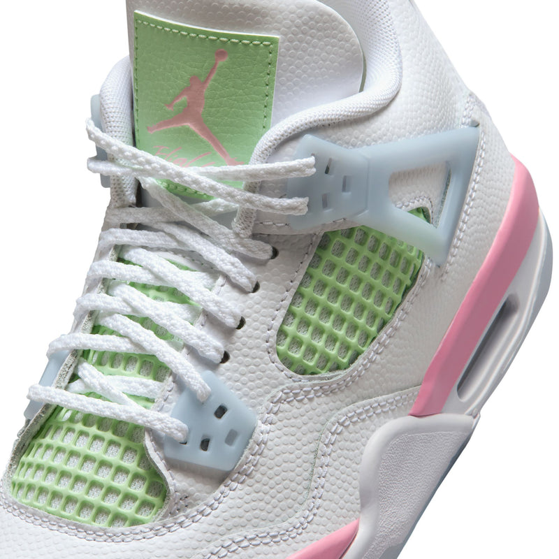Close-up youth sneaker: white leather with green mesh, light blue overlays, pink Jumpman detail.
