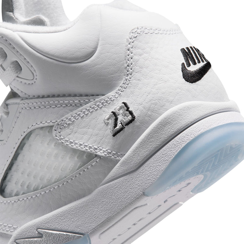 Kids white sneaker side close-up with black logo and textured midsole