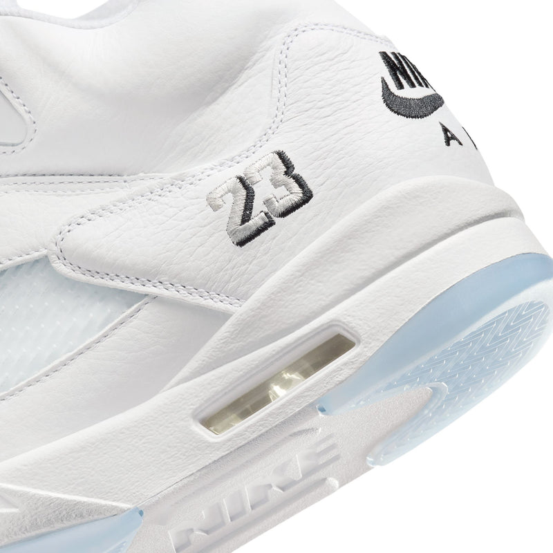Men's Retro 5 side close-up with white leather, molded detail, and light-blue translucent sole
