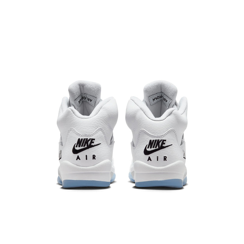 Youth white sneakers, rear view with Nike Air branding and light blue soles