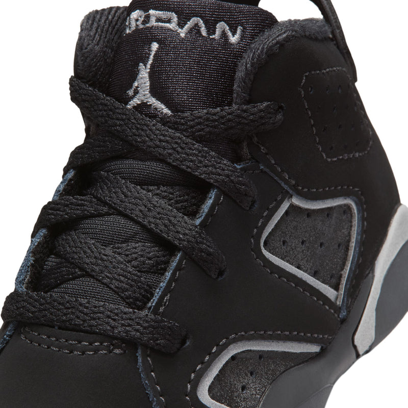 Black toddler sneaker upper close-up with laces, stitched panels, and heel logo