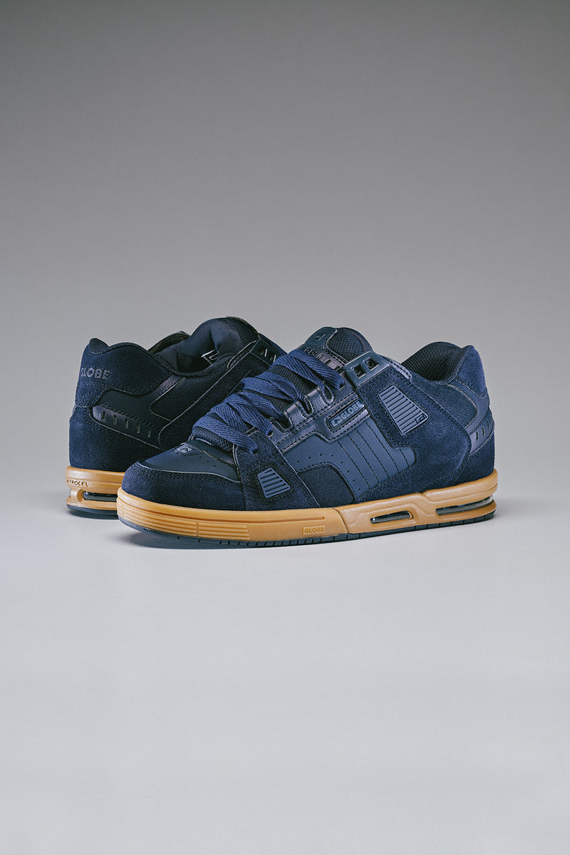 Pair of navy Sabre skate shoes with gum soles and rugged panel details