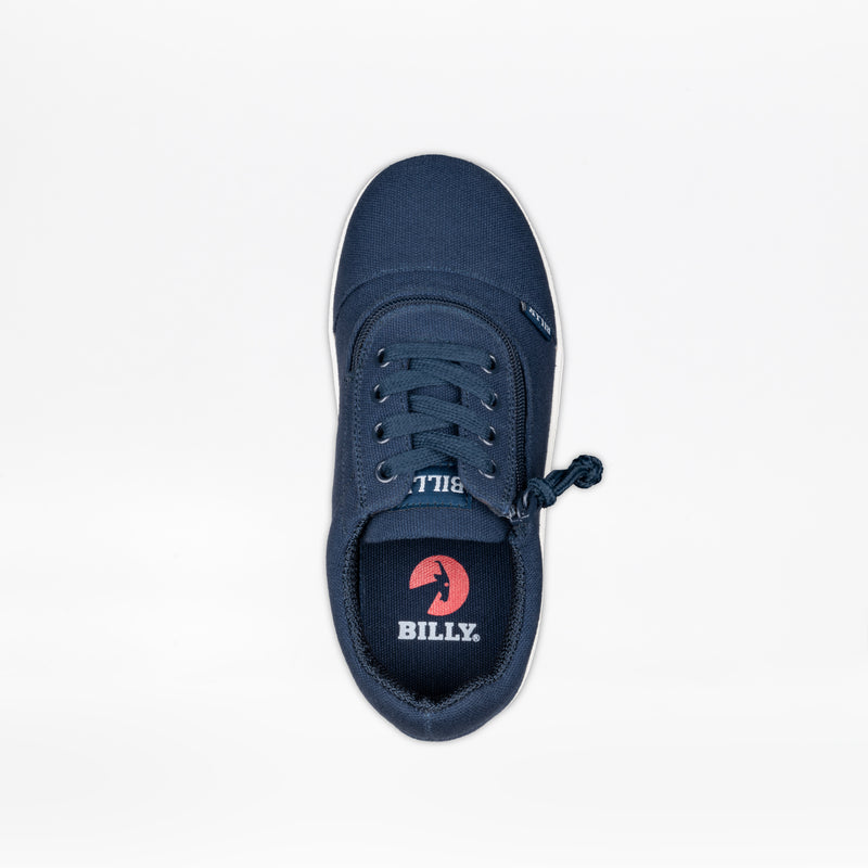 The SALE - Navy BILLY D|R II Short Wrap Low by BILLY Footwear is a kids adaptive sneaker with navy canvas, a knotted lace on one side, metal eyelets, and a red circular BILLY logo on the insole.