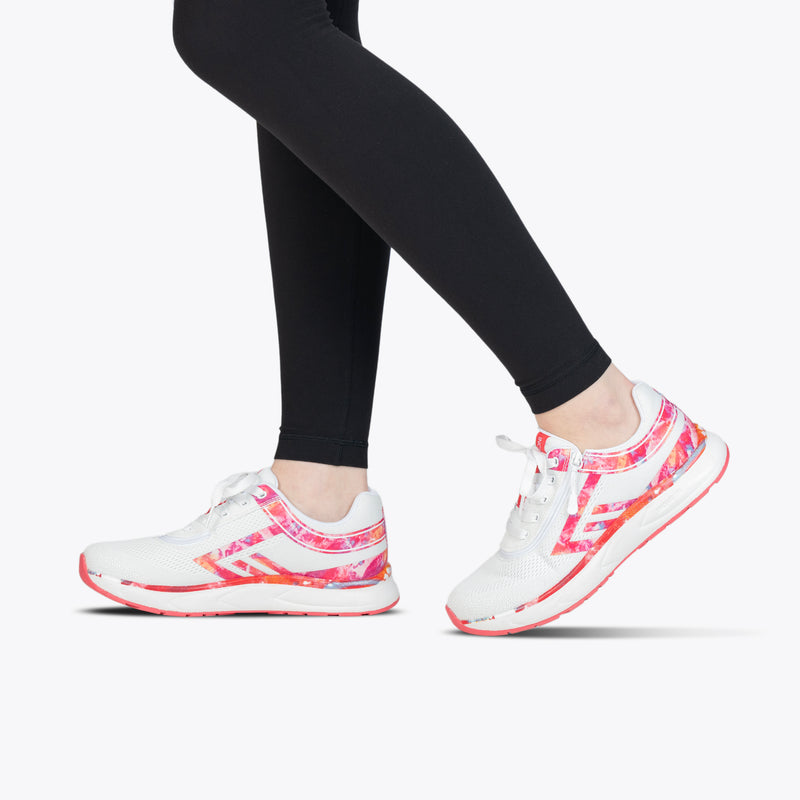 A person in black leggings and SALE - Women's Pink Marble BILLY Sport Inclusion sneakers by BILLY Footwear, featuring pink and red accents, stands on tiptoe against a plain white background.