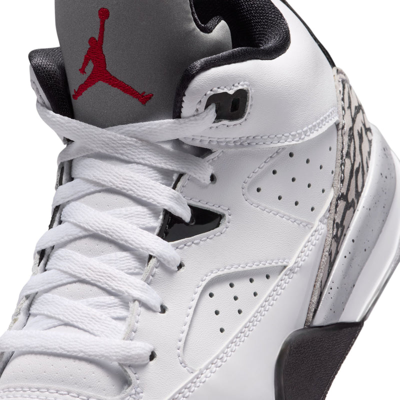 Kids high-top shoe close-up: white upper with red Jumpman on grey tongue.