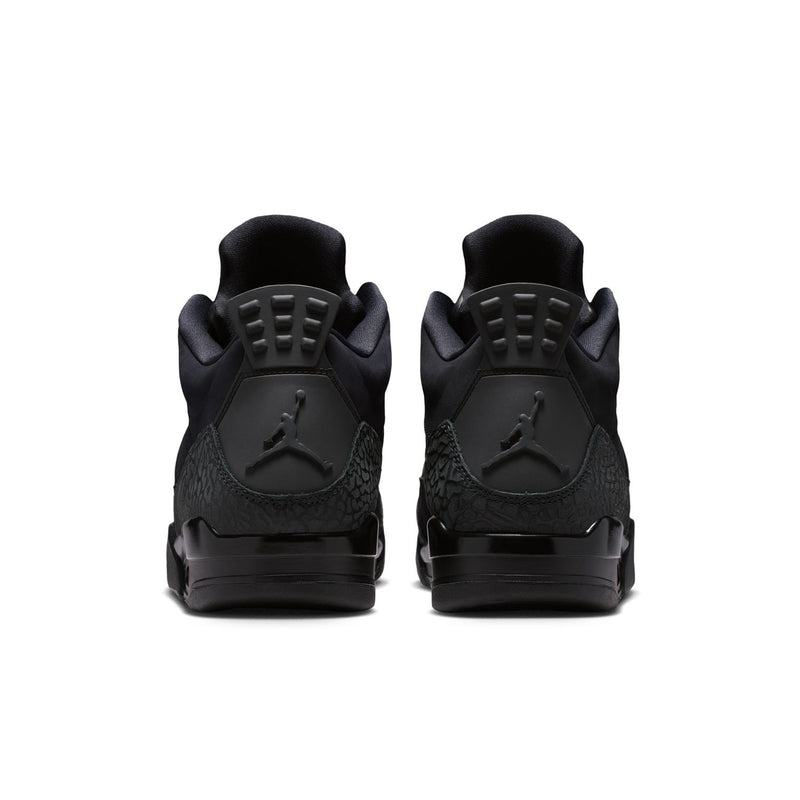 Black low-top sneakers with molded heel counter and Air-style traction tread