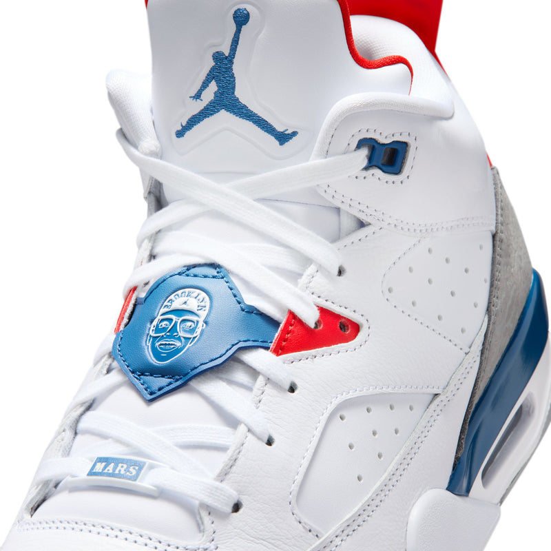 Men's white leather low-top sneakers with blue heel patch and red details, lace-up