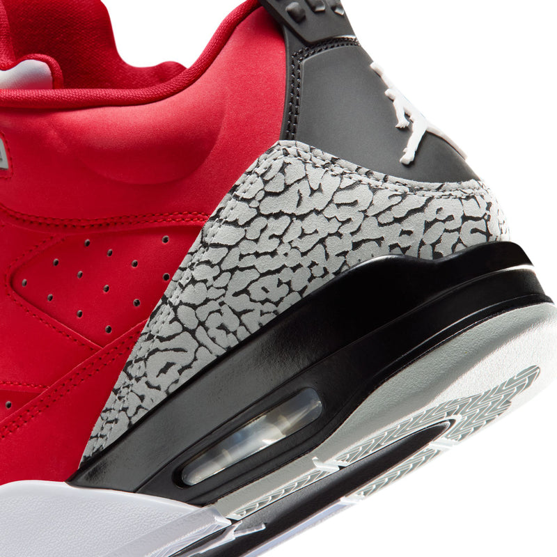 Side close-up of red sneaker with air unit window, grey speckled panel, and black trim