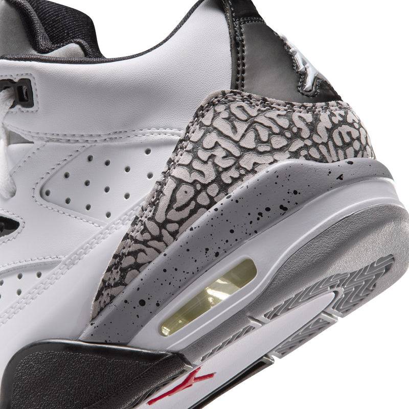 Youth sneakers close-up: white upper with black cement print, visible air sole window