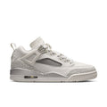 White low-top sneaker with lace-up closure, gray mesh panels, and air-cushion sole